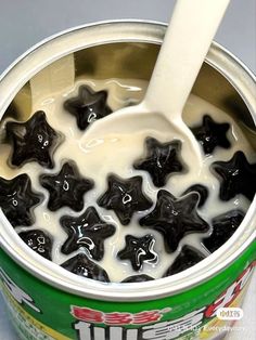 a cup filled with milk and black stars