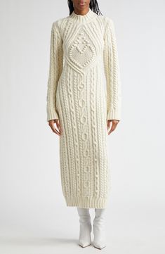 A heart-centered sweater-dress is Italian knit in a fitted, ankle-grazing silhouette in a mix of cable stitches from a virgin wool blend and evokes the siren call of the sea. Slips on over head Mock neck Long sleeves Ribbed cuffs and hem Unlined 50% virgin wool, 50% polyester Dry clean Made in Italy Designer Clothing Formal Sweater, Siren Call, Cashmere Sweater Dress, The Siren, Runway Dresses, Style Inspiration Fall, Paul Gaultier, Wool Blend Sweater, Free Fabric