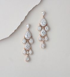 "Beautiful cascading waterfall teardrop earrings are a perfect accessory for bride or bridesmaid. Created with Swarovski Pure Brilliance stones in 3 different finishes. Available in rhodium, rose gold and yellow gold Earrings measure 2-1/2\" x 7/8\" Matching pieces: https://www.etsy.com/listing/674474135/rose-gold-bridal-bracelet-teardrop?ref=shop_home_active_1&pro=1&frs=1 https://www.etsy.com/listing/273104988/rose-gold-necklace-bridal-necklace?ref=shop_home_active_33 https://www.etsy.c Rose Gold Drop Bridal Earrings, Rose Gold Drop Bridal Earrings For Anniversary, Glamorous Rose Gold Dangle Chandelier Earrings, Rose Gold Dangle Chandelier Earrings, Rose Gold Dangle Chandelier Earrings For Formal Events, Rose Gold Long Drop Earrings For Wedding, Drop Chandelier Earrings For Wedding, Air Jewelry, Rose Gold Chandelier