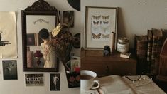 there are many pictures on the wall and coffee cup in front of them, along with an open book