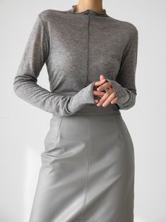 Long sleeve t-shirt with half turtleneck and stitching details. Sheer fabric look in tencel wool blend. Model is in MINUSEY ONE SIZE. ✔️ Free worldwide express shipping over $100✔️ Loved by 6,500+ customers✔️ Limited edition collections, maximum style⠀⠀⠀⠀⠀⠀⠀⠀⠀Stay ahead of the trend with can’t-find-anywhere-else staples. Your closet will thank you 💕 * MINUSEY ONE SIZE = EU 34-38, US 2-6* 70% Tencel / 30% Wool* Dry clean* Made in Korea - Model Height: 170cm/5'7" (US2, EU34) Gray Funnel Neck Top For Layering, Gray High Neck Tops For Layering, Stretch T-shirt For Winter Layering, Fitted Turtleneck T-shirt, Gray Turtleneck Top For Layering, Stretch Mock Neck Top For Layering, Gray Fine Knit Top For Layering, Gray Winter Tops With Thumbholes, Stretch T-shirt For Workwear In Fall