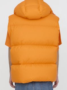 Apus down vest in orange nylon with nylon lining and down filling. It features detachable hood, front two-way zip closure, side welt pockets, side zip pockets and hem with drawstring. Logo patch on chest. Oversized fit. The model is 184cm tall and wears size 03.Size nationality: US Product number: 341207 Product code: 1A00005M3381328 Composition: 100% polyamide Winter Orange Sleeveless Vest, Orange Sleeveless Winter Vest, Hooded Nylon Vest For Outdoor, Casual Nylon Vest With Detachable Hood, Outdoor Sleeveless Vest With Detachable Hood, Sleeveless Vest With Detachable Hood For Outdoor, Hooded Puffer Vest For Outdoor, Functional Nylon Vest With Detachable Hood, Nylon Outerwear With Detachable Hood