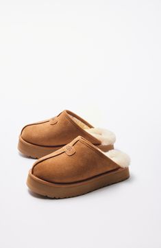 Plush comfort and the UGG look you know and love are both in store when you step into this slide slipper made from genuine shearling in an array of hues. 2 1/4" heel; 1 1/2" platform (size 11) Slight dye transfer may occur with darker colors during first few wears Genuine-shearling upper and lining/synthetic sole Shearling may be sourced from Australia, Ireland, Spain, the UK or the USA. See packaging for confirmed country of origin Imported Uggs Boots, Nylon Travel Bag, Buy Boots, Shearling Slippers, Xmas List, Emily Henderson, Ugg Slippers, Cute Boots, Nordstrom Anniversary Sale