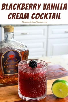 the blackberry vanilla cream cocktail is garnished with fresh blackberries and limes