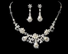 "Exquisite wedding necklace earring set with ivory freshwater pearls, dazzling clear rhinestones and fabulous clear Austrian crystal beads all set in stunning gold or silver plating in a vintage inspired floral design. This wedding jewelry set will make you feel absolutely beautiful and will look wonderful on any classic or vintage inspired bride with a white,ivory,champagne or blush wedding dress. READY TO SHIP in Silver, Gold sold out. DETAILS: - Necklace - Necklace: 15\" long with a 2\" adjus White Pearl Bridal Earrings With Diamond Accents, Pearl Bridal Earrings With Diamond Accents For Wedding, Bridal Pearl Earrings With Diamond Accents For Wedding, Elegant White Crystal Jewelry Sets, White Pearl Jewelry With Rhinestones, Silver Pearl Jewelry With Rhinestones, Wedding Jewelry With Pearl And Diamond Accents, Wedding Jewelry With Pearl And Rhinestones, Wedding Pearl Necklace With Diamond Accents