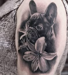 a black and white photo of a dog with flowers on it's back shoulder