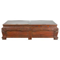 an old wooden trunk with carvings on the top and bottom, sitting against a white background