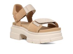 UGG Ashton Ankle - Women's Shoes : Sand : Designed for all-day comfort, the UGG Ashton Ankle Heeled Sandals come with an open toe design. Nubuck upper with UGG webbing. Microfiber lining. EVA footbed. Custom fit. Adjustable ankle and vamp-strap takes your outfit to new heights. Hook-and-loop closure on the straps. Round toe design. Chunky EVA and rubber outsole. Imported. Measurements: Heel Height: 2 3 4 in Product measurements were taken using size 7, width B - Medium. Please note that measurements may vary by size. Comfortable Beige Sport Sandals With Round Toe, Comfortable Beige Sport Sandals, Beige Adjustable Sport Sandals With Round Toe, Adjustable Beige Sport Sandals, Ugg Shoes Women, Ankle Sandals, Ankle Heels, Toe Designs, Heeled Sandals