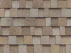 a close up view of a shingled roof with brown and tan tiles on it