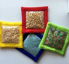 four different colored squares with seed in them on a white surface, one has a blue square and the other is a yellow square