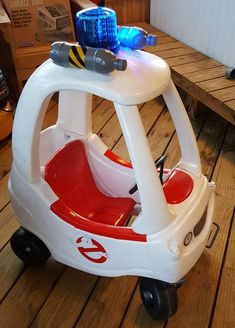 a small toy car sitting on top of a wooden floor