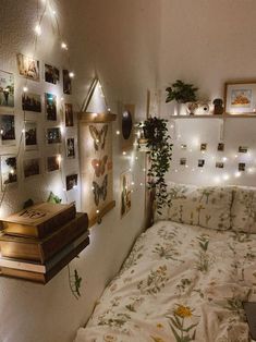 an instagram photo of a bedroom with lights on the wall and pictures hanging above the bed