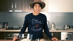 a man standing in front of a kitchen counter with bowls and food items on it