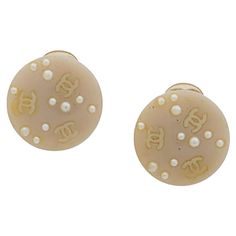 2003 beige Chanel logo clip-on earrings featuring faux-pearls embellishment, signature interlocking CC logo, , a back claps earring, a back logo plaque. These earrings come as a pair. Diameter: 1.7cm In good vintage condition. Made in France. We guarantee you will receive this iconic item as described and showed on photos. (please enlarge images to see all details on photos) Pearls Embellishment, Chanel Logo, Chanel Jewelry, Logo A, Cc Logo, Clip On, Made In France, Clip On Earrings, Faux Pearl