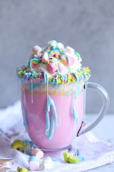 a cup filled with ice cream covered in candy and marshmallows