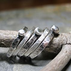 Set of FIVE stacking rings. Rustic stacking pebble rings accented by two textured fine silver bands. The 3 stackable sterling silver pebbles have been given an oxidized finish that is a great contrast to the two satin textured bright white fine silver accent rings. Meant to be slightly organic in shape, this rustic stack is a great casual, everyday look. They are also fun to play with, changing the position of the pebbles according to mood. when stacked on top of each other, they remind me of th Accent Rings, Pebble Ring, Lavender Cottage, Silver Bands, Bee Ring, Artisan Jewelry Handmade, Hammered Sterling Silver, Nature Jewelry, Silver Accents