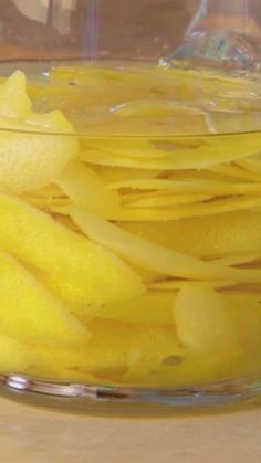 a glass bowl filled with sliced yellow fruit