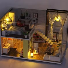 a doll house with furniture and lights inside