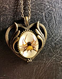 "Its an adult Spiny Orb Weaver spider, centered and encased in clear resin with white backing, mounted on an ornate bronze colored setting, hung on a matching 18\" chain. The cameo is such high relief, it looks like the spider is floating! The Cabochon alone is 18x25mm. Talk about a conversation starter! Why leave your curiosities on the shelf? Take them with you! For more info, updates, and contests, check out my Instagram page @thecuriositeer" Real Bug Jewelry, Halloween Resin Jewelry Gift, Halloween Gift Resin Jewelry, Bug Resin, Spiny Orb Weaver, Orb Weaver Spider, Resin Jewlery, Orb Weaver, Ornate Necklace