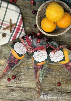 oranges and other fruit are on display in glass cones with tags attached to them