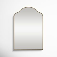 a mirror that is on the wall next to a white wall with a black frame