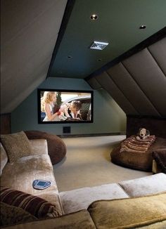 a home theater in the corner of a room with two couches and a television