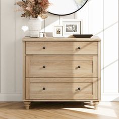 a dresser with drawers and a mirror on the wall