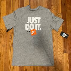 Nike Men’s T-Shirt Nwt Size: Medium Color: Gray/White/Orange Nike Orange Crew Neck T-shirt, Nike Gray T-shirt With Logo Print, White Nike T-shirt With Text Print, Nike Short Sleeve T-shirt With Branding, Shirts Nike, Men T Shirt, Nike Shirts, Men's Nike, Gray White