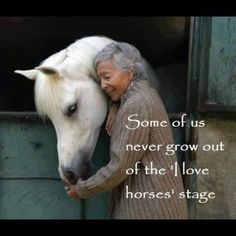 an old woman is petting a white horse