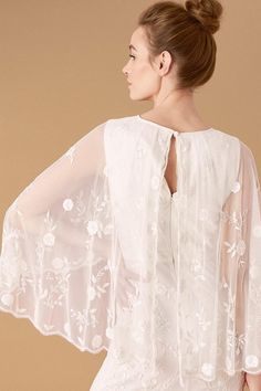 Designed for the free-spirited bride, Zoey is cut with angel sleeves that emerge into a floaty, cape-style layer on the reverse. Floral-embroidered mesh with pearlised sequins offer a feminine touch, whilst the hem mimics a fishtail silhouette that flatters all body shapes. Ivory Wedding Dresses, Floral Cape, Angel Sleeves, Bridal Wedding Dress, Cape Style, T Dress, Ivory Wedding Dress, Brides Wedding Dress, New Wedding Dresses