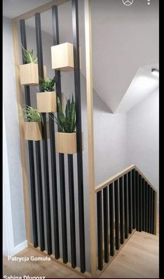 an image of a stair case with plants on the top and bottom railings above it