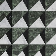 a black and white checkerboard pattern made up of marble blocks with green veining