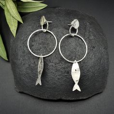 "This beautiful pair of earrings is composed by little silver fishes and rings. Thanks to its lightness, the various pieces have a great capacity of movement. Very easy to wear,capable of giving you a natural and rustic touch. I hammered them piece by piece, to give you all the most unique result! This piece is entirely made by myself, soldering sterling silver (925) with traditional Jewelry techniques. Every piece is unique! Dimensions: Lenght: 3.18\" 81mm Width: 1.29\" 33mm The earrings will b Handmade Fish-shaped Earrings For Gifts, Silver Sterling Fish-shaped Earrings, Silver Fish-shaped Sterling Silver Earrings, Handmade Silver Fish-shaped Earrings, Silver Fish-shaped Earrings With Ear Wire, Handmade Sterling Silver Fish-shaped Jewelry, Nickel-free Silver Fish-shaped Earrings, Handmade Sterling Silver Fish Jewelry, Fish Earrings