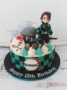 a birthday cake with an anime character on top