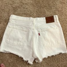 White Levi’s Jean Shorts, Never Worn!! Fits Large Cutoff Shorts With Pockets For Vacation, Cutoff Bottoms With Pockets For Vacation, Cutoff Cotton Bottoms For Vacation, White Cutoff Summer Bottoms, Cotton Cutoff Bottoms For Vacation, White Mid-rise Jean Shorts With Built-in Shorts, Vacation Cutoff Bottoms With Pockets, White Jean Shorts For The Beach, White High Rise Bottoms For Day Out