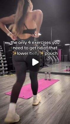 a woman standing on top of a pink yoga mat in front of a gym machine