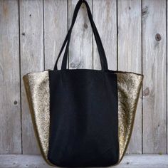 A gorgeous combo of black leather and an incredible gilded exterior and shearling interior on the sides, this bag is an eye catcher. Flawlessly handmade, it has an interior pocket with label and gorgeous signature zipper pull. Luxe Black Shoulder Bag For Everyday Use, Luxury Reversible Rectangular Shoulder Bag, Black Leather Reversible Shoulder Bag, Reversible Black Leather Shoulder Bag, Chic Gold Bag With Leather Trim, Elegant Reversible Shoulder Bag, Black Leather Bag With Suede Lining, Elegant Reversible Tote Shoulder Bag, Chic Black Reversible Bags