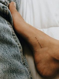 a person's foot with the word love written on it in cursive font