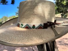 3/4" wide. This hat band is finished at 23" with glued down faux leather ends and an 24" adjustable leather tie. Western Style Adjustable Top Hat For Outdoors, Adjustable Hat Bands For Country Events In Spring, Adjustable Country Style Top Hat For Outdoor, Adjustable Top Hat With Flat Crown For Ranch, Adjustable Brown Boater Hat With Flat Crown, Adjustable Brown Boater Hat With Flat Brim, Adjustable Leather Hat Bands With Flat Brim, Adjustable Wide Brim Boater Hat For Ranch, Adjustable Leather Hat With Flat Crown