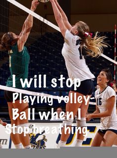 two girls are playing volleyball and one is jumping up to hit the ball