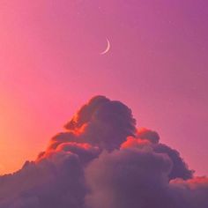 the moon is in the purple sky above some clouds