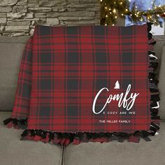 a red and black plaid christmas blanket with the words cozy are we written on it