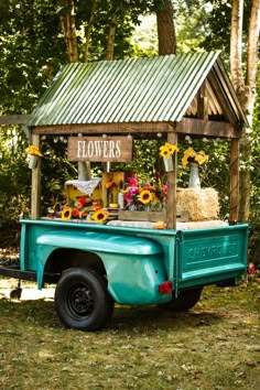 an old pickup truck with flowers on the back