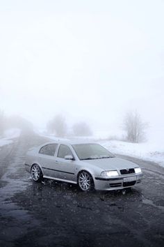 a car parked on the side of a snowy road