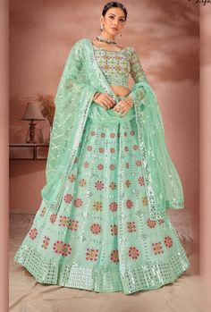 This exquisite Multicolour Lehenga Choli is crafted with premium Georgette and Raw Silk, ensuring a luxurious and high-quality piece. With its stunning design and materials, this dress offers a sophisticated and elegant look for any occasion. Elevate your wardrobe with this must-have piece. LEHENGA FABRIC: Premium Georgette, Premium Net BLOUSE FABRIC: Premium Georgette, Premium Raw Silk DUPATTA: Net SIZING: Can be stitched upto 42 inches bust and waist SHIPPING: The product will be shipped withi Green Lehenga Choli, Heavy Lehenga, Georgette Lehenga, Party Wear Lehenga Choli, Sea Green Color, Net Blouses, Green Lehenga, Lehenga Blouse, Designer Lehenga