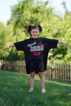 These make such a fun way to see how much your child has grown over the years. The shirt is a black unisex adult medium. White Text with a colored graduation cap and personalized with child's name. Colors offered are Pink, Blue, Green, Yellow, Orange and Red. Black Short Sleeve School Spirit Top, Casual Black Tops For School Events, Black Casual Tops For School Events, Black Short Sleeve T-shirt For School Events, Black Letter Print Top For School, Black Short Sleeve Tops For School Events, Black School Spirit Tops For School Events, Black Tops For School Events With School Spirit, Black Tops For End Of School Year Events