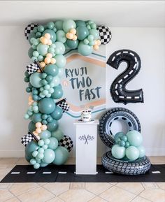 balloons are arranged in the shape of numbers and race track signs for a two - year birthday party