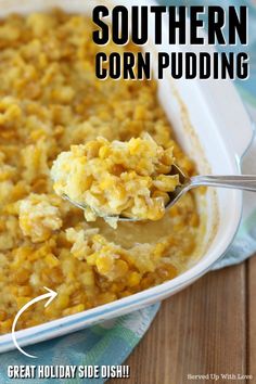 a spoon full of corn pudding in a white casserole dish with the words corn pudding above it