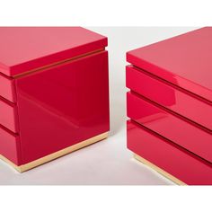 two red drawers with gold trims on each drawer and one has a white background