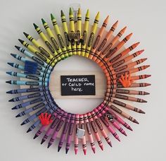 there is a circle made out of crayons with a sign that says teacher or child name here